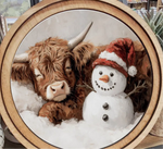 Load image into Gallery viewer, Cow Sleeping by Red White Hat Snowman Round Wood Frame Christmas Decor
