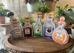 Load image into Gallery viewer, Halloween Potion Bottles Metal Stakes with Easels Black, Purple, Orange, and Yellow with her Frog Roundtop Collection
