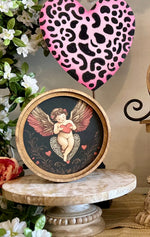 Load image into Gallery viewer, Round Top Wooden Cupid Art in Black, Pink, and Red
