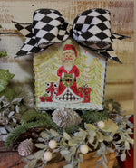 Load image into Gallery viewer, Santa in Harlequin Trees in Background Mini Print
