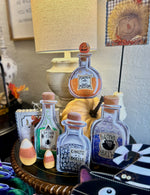 Load image into Gallery viewer, Halloween Potion Bottles Metal Stakes with Easels Black, Purple, Orange, and Yellow with her Frog Roundtop Collection
