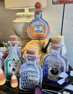 Load image into Gallery viewer, Halloween Potion Bottles Metal Stakes with Easels Black, Purple, Orange, and Yellow with her Frog Roundtop Collection
