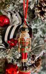 Load image into Gallery viewer, Plaid Nutcracker Ornament in Red, Dark Green, White and Gold with Black Accents
